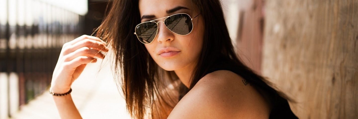 183573-women-model-brunette-long_hair-Black_clothes-tattoo-sunglasses-women_outdoors-walls-sunlight-tank_top